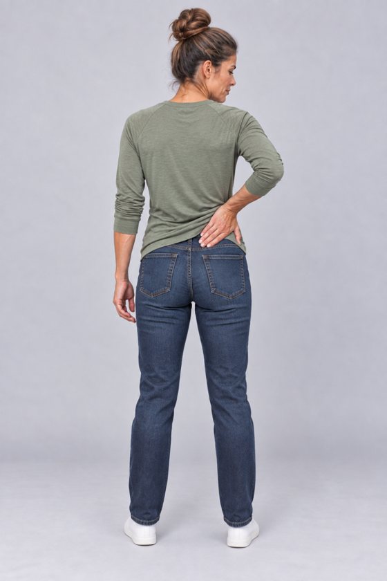 Woman seen from behind, holding her lower back